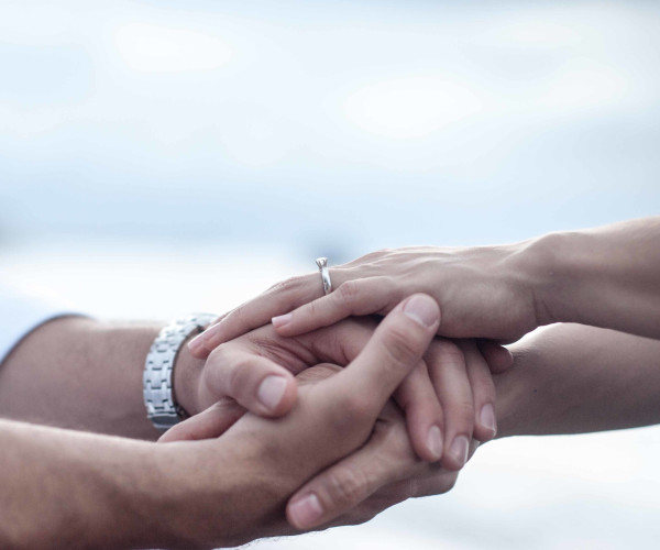 Engaged couple wearing diamond engagement ring