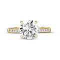 2.50 carat solitaire ring in yellow gold with four prongs and side diamonds