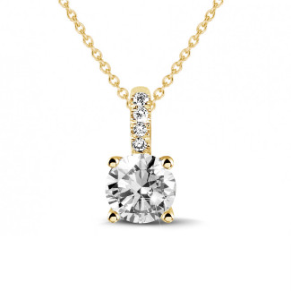 1.25 carat solitaire pendant in yellow gold with four prongs and round diamonds