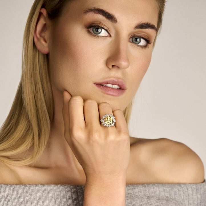 Entourage ring in white gold with ‘fancy intense yellow’ cushion diamond and oval and pear shaped  diamonds