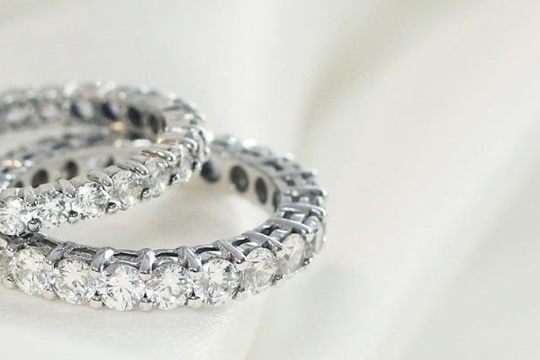 Two eternity diamond wedding rings on fabric