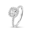 0.70 carat solitaire halo ring with a cushion diamond in white gold with round diamonds