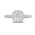0.70 carat solitaire halo ring with a cushion diamond in white gold with round diamonds