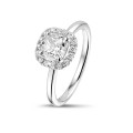 1.20 carat solitaire halo ring with a cushion diamond in white gold with round diamonds