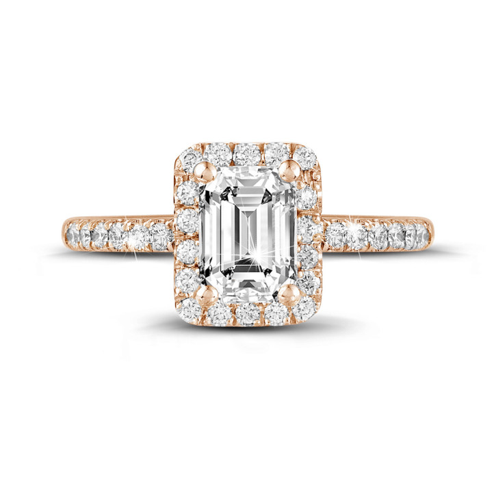 0.70 carat solitaire halo ring with an emerald cut diamond in red gold with round diamonds
