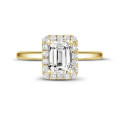 1.50 carat solitaire halo ring with an emerald cut diamond in yellow gold with round diamonds