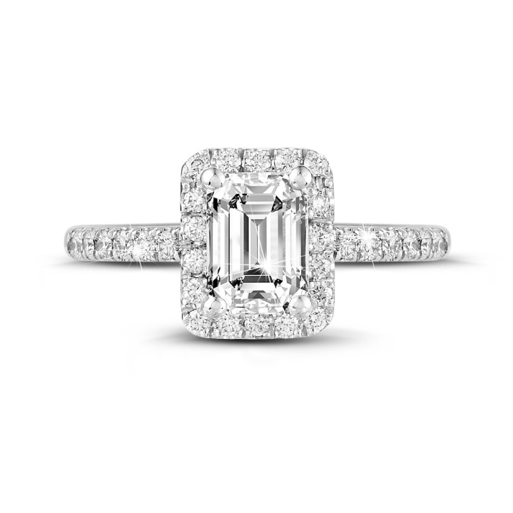 2.00 carat solitaire halo ring with an emerald cut diamond in white gold with round diamonds