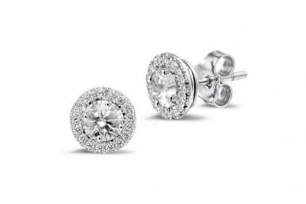 Three varieties of diamond halo earrings arranged elegantly, highlighting their diverse shapes and exquisite craftsmanship.