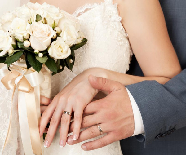 Bride and groom holding hands 