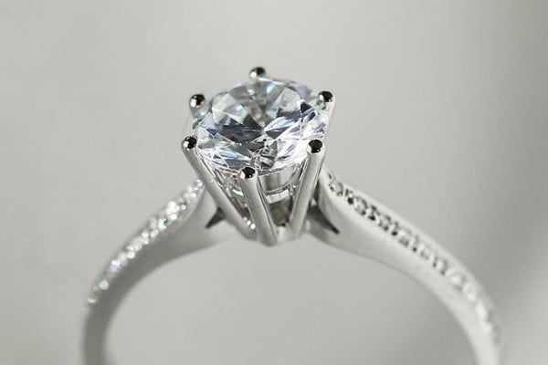 Diamond solitaire engagement ring on elegant fabric