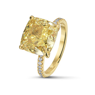 Engagement - 7.07ct solitaire ring in yellow gold with ‘fancy intense yellow’ cushion diamond and side stones 