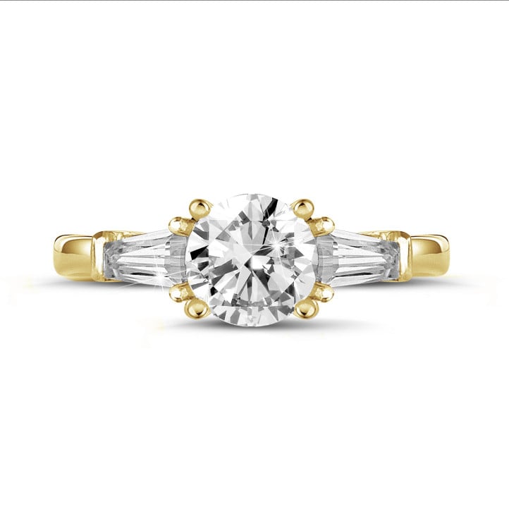 1.00 carat trilogy ring in yellow gold with a round diamond and tapered baguettes