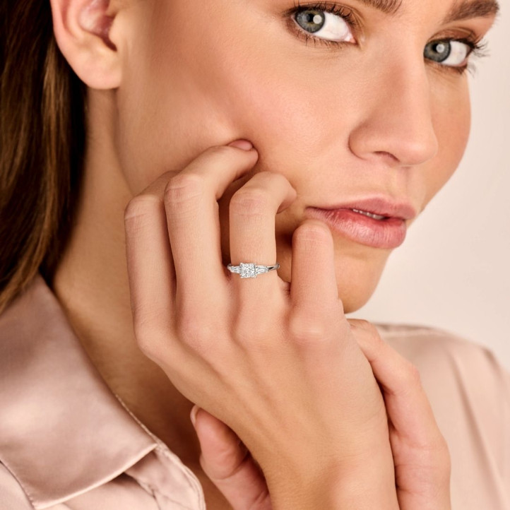 1.00 carat trilogy ring in red gold with a princess diamond and tapered baguettes
