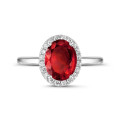 Halo ring in white gold with an oval ruby