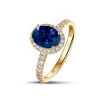 Halo solitaire ring in yellow gold with an oval sapphire and small diamonds