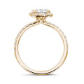1.20 carat solitaire halo ring with a radiant cut diamond in red gold with round diamonds
