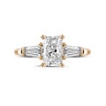 1.00 carat trilogy ring in red gold with a radiant cut diamond and tapered baguettes