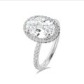 Bespoke halo ring with an oval cut diamond