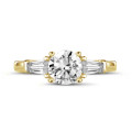 2.00 carat trilogy ring in yellow gold with a round diamond and tapered baguettes