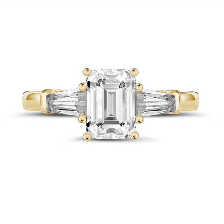 2.00 carat trilogy ring in yellow gold with an emerald cut diamond and tapered baguettes