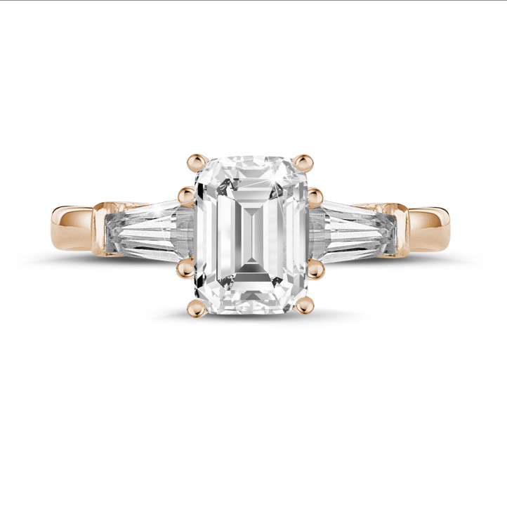 2.00 carat trilogy ring in red gold with an emerald cut diamond and tapered baguettes