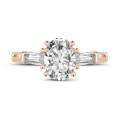 2.00 carat trilogy ring in red gold with oval diamond and tapered baguettes