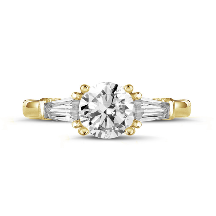 1.50 carat trilogy ring in yellow gold with a round diamond and tapered baguettes