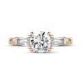 1.50 carat trilogy ring in red gold with a round diamond and tapered baguettes