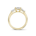 1.50 carat trilogy ring in yellow gold with an emerald cut diamond and tapered baguettes