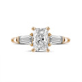 1.50 carat trilogy ring in red gold with a radiant cut diamond and tapered baguettes
