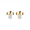 0.30 carat solitaire earrings with oval cut diamonds in yellow gold