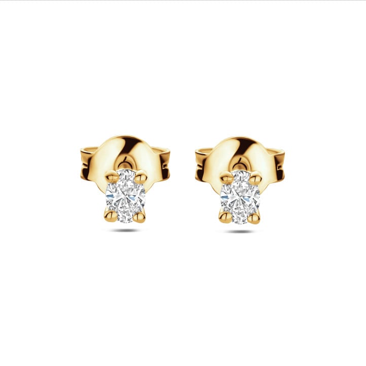 0.30 carat solitaire earrings with oval cut diamonds in yellow gold