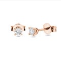 0.30 carat solitaire earrings with round cut diamonds in red gold