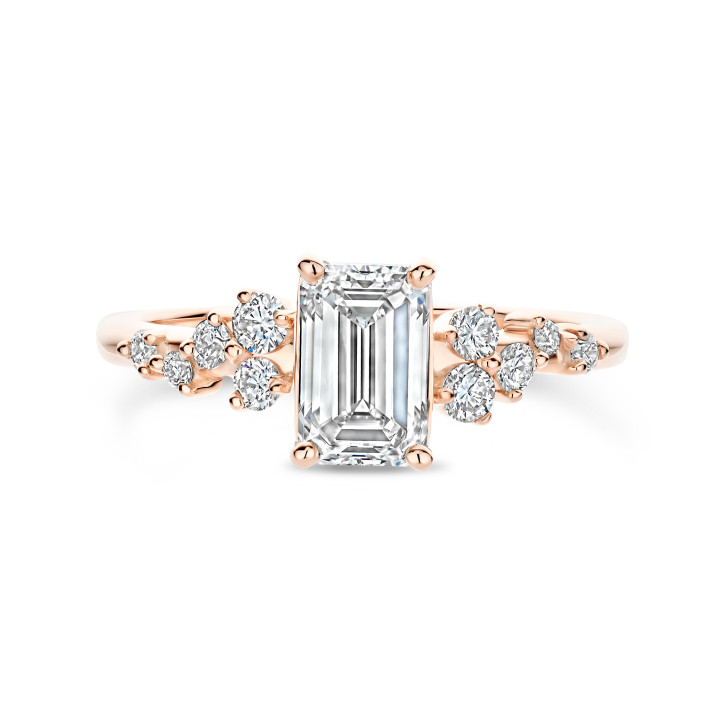 0.70 carat solitaire cluster ring in red gold with an emerald cut diamond
