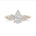 1.00 carat solitaire cluster ring in red gold with a pear cut diamond