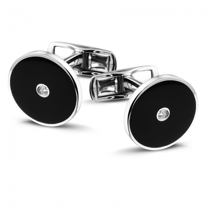 White golden cufflinks with onyx and a central diamond