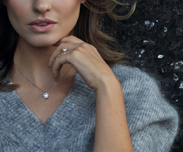 Woman wearing diamond necklace and diamond ring