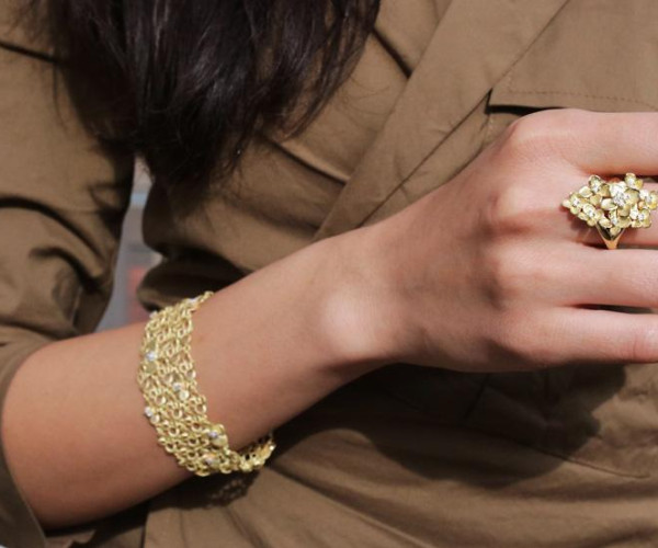 Woman wearing floral diamond bracelet and ring