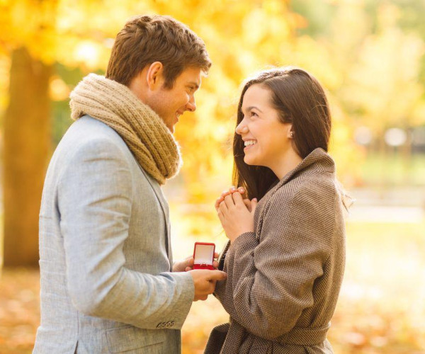 Man proposes to a woman with an engagement ring 