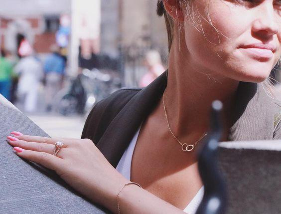 Woman wearing diamond ring and necklace in the city