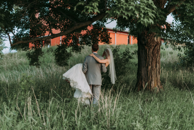 couple enjoying their beautiful intimate wedding surrounded by a beautiful green countryside landscape