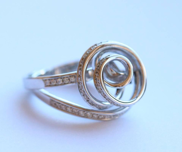 Diamond ring from the Dancing Lady collection on blue backdrop