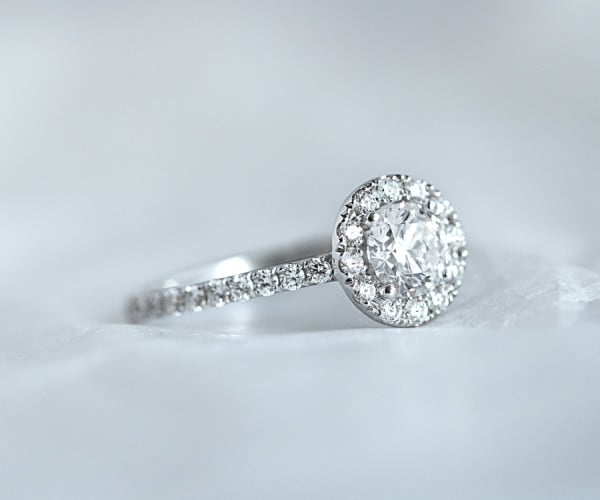 A beautiful platinum engagement ring featuring a sparkling diamond, displayed on a pristine white background