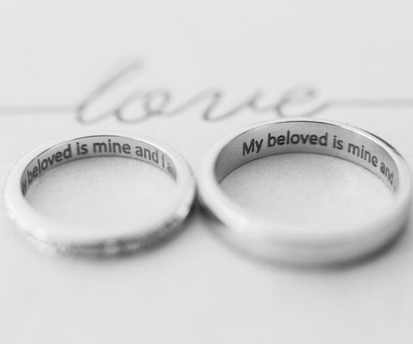 Beautifully crafted wedding rings inscribed with love quotes, capturing the essence of love and unity in a marriage.