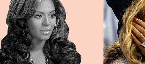 Beyonce wearing an engagement ring with diamonds.