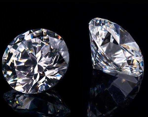 Two real natural brilliant diamonds on black background