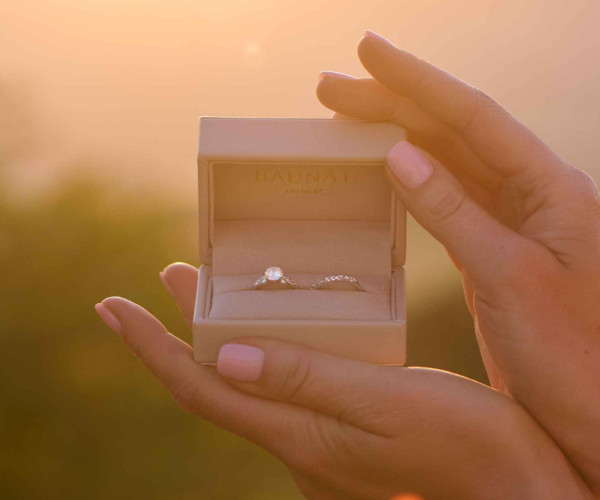 Engagement ring in a box with the sunset