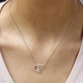 Collana con diamante da 0,20 carati in oro bianco con design a forma di infinito