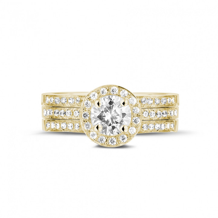Anello solitario con diamante da 0,70 carati in oro giallo con diamanti laterali