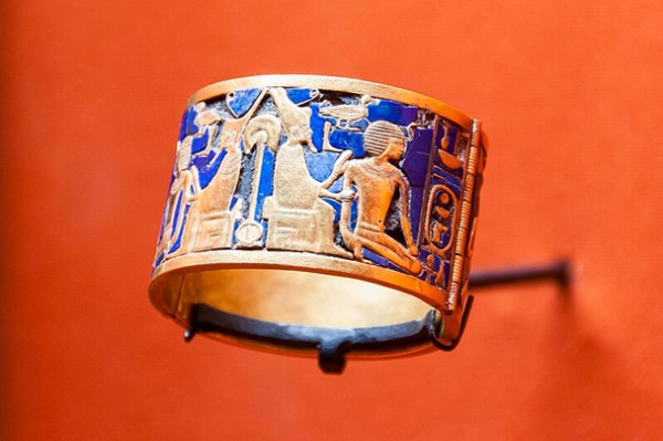 A beautifully crafted Egyptian bracelet adorned with gold and blue enamel, identified as the Bracelet of Ahhotep